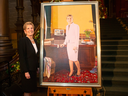 Former Ontario Premier Kathleen Wynne stands beside her portrait, painted by Linda Dobbs, after its unveiling ceremony at the Ontario Legislature, in Toronto, Dec. 9, 2019.