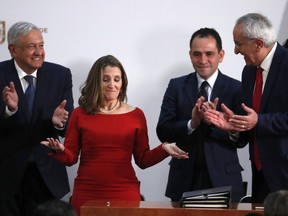 Deputy Prime Minister of Canada Chrystia Freeland, second left, acknowledges the applause as Mexico's top trade negotiator Jesus Seade, right, Mexico's Treasury Secretary Arturo Herrera, second right, and Mexico's President Andres Manuel Lopez Obrador, left, applaud after signing an update to the North American Free Trade Agreement, at the national palace in Mexico City, Tuesday, Dec. 10. 2019.
