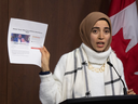 Amal Ahmed, daughter of Yasser Albaz, currently detained in Egypt, holds up a petition for his release during a news conference, Dec. 11, 2019 in Ottawa.