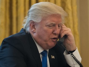 President Donald Trump speaks on the phone with Chancellor of Germany Angela Merkel in the Oval Office of the White House, Jan. 28, 2017 in Washington, DC.