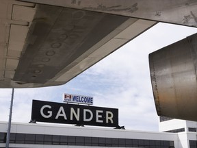 Gander Airport, Newfoundland, airport sign seen from under wing of a plane.