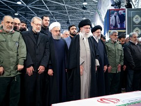 Iran's Supreme Leader Ayatollah Ali Khamenei and Iranian President Hassan Rouhani pray near the coffin of Iranian Major-General Qassem Soleimani, head of the elite Quds Force, who was killed in an air strike at Baghdad airport, in Tehran, Iran, January 6, 2020.