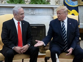 U.S. President Donald Trump shakes hands with with Benjamin Netanyahu, Israel's prime minister, left, during a meeting in the Oval Office of the White House in Washington, D.C., U.S., on Monday, Jan. 27, 2020.
