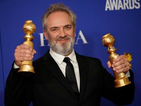 Sam Mendes poses backstage with his awards for Best Director - Motion Picture and Best Motion Picture - Drama for 1917.