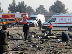 In this file photo taken on Jan. 8, 2020, rescue teams work amidst debris after a Ukrainian plane carrying 176 passengers crashed near Imam Khomeini airport in the Iranian capital Tehran, killing everyone on board.