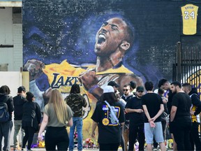 Fans gather to mourn the death of NBA legend Kobe Bryant at a mural near Staples Center in Los Angeles, California on January 27, 2020.