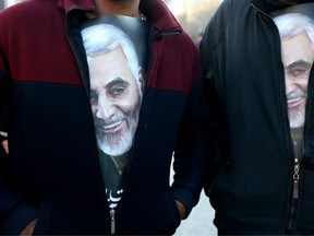 Iranian mourners wearing t-shirts with pictures of slain top general Qasem Soleimani during the final stage of funeral processions in his hometown Kerman on January 7, 2020.