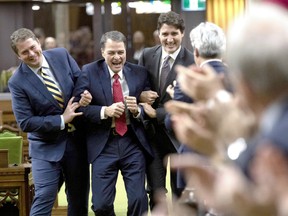 Prime Minister Justin Trudeau and Leader of the Opposition Andrew Scheer drag Nipissing-Timiskaming Liberal MP Anthony Rota to the Speaker's chair after he was elected as the new Speaker of the House of Commons, in Ottawa, Dec. 5.