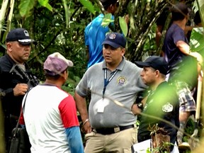Grab taken from Panamanian channel TVN Noticias showing Panamanian police and employees of the Public Ministry near the site where a mass grave was found with seven bodies at the indigenous region of Ngabe Bugle, in Bocas del Toro province, Panama, on January 15, 2020.