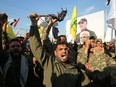 Members of the Hashed al-Shaabi paramilitary force chant anti-U.S. slogans during a protest over the killings of Iranian commander Qassem Soleimani and Iraqi paramilitary commander Abu Mahdi Al-Muhandis, on January 6, 2020 in Karrada in central Baghdad.