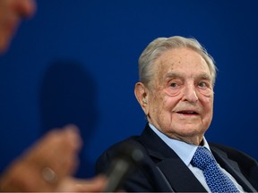 Hungarian-born U.S. investor and philanthropist George Soros (R) listens to Human Rights Watch director Kenneth Roth after delivering a speech on the sidelines of the World Economic Forum (WEF) annual meeting, on January 23, 2020 in Davos.