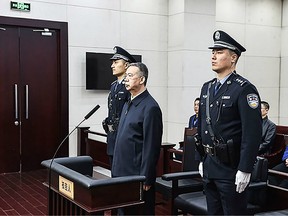 This handout photo taken on January 21, 2020 and released by the Tianjin First Intermediate People's Court shows former Interpol chief Meng Hongwei (C) during his sentencing at the court in the Chinese city of Tianjin.