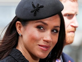 In this file photo taken on April 25, 2018 Britain's Prince Harry and Meghan Markle arrive to attend a service of commemoration and thanksgiving to mark Anzac Day in Westminster Abbey in London.