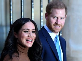 In this file photo taken on January 07, 2020 Britain's Prince Harry, Duke of Sussex and Meghan, Duchess of Sussex react as they leave after her visit to Canada House in thanks for the warm Canadian hospitality and support they received during their recent stay in Canada.