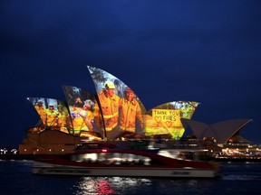 The sails of the Opera House are lit with a series of images to show support for the communities affected by the bushfires and to express the gratitude to the emergency services and volunteers in Sydney on Jan. 11, 2020.