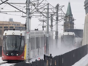 OC Transpo light rail trains pass each other near downtown Ottawa, Tuesday, January 21, 2020.