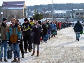 Customers line up at a Sobeys grocery store in St. John’s on Tuesday as a state of emergency ordered by the city continues, leaving most businesses closed and vehicles off the roads in the aftermath of the major winter storm that hit the Newfoundland and Labrador capital.