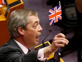 Brexit Party leader Nigel Farage brandishes a Union Jack flag at the European Parliament in Brussels, Belgium January 29, 2020.