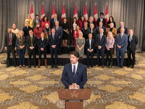 Prime Minister Justin Trudeau stands in front of his cabinet as he speaks to media during the final day of the Liberal cabinet retreat at the Fairmont Hotel in Winnipeg, Tuesday, Jan. 21, 2020.