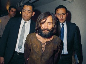 Charles Manson is escorted to his arraignment on conspiracy-murder charges in connection with the Sharon Tate murder case in 1969.