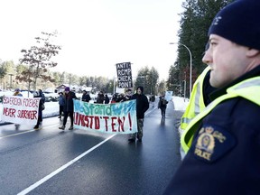 Supporters of the Wet’suwet’en nation indigenous group who oppose the construction of the Coastal GasLink pipeline, protest outside the provincial headquarters of the RCMP in Surrey, B.C.