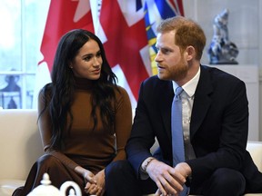 Britain's Prince Harry and Meghan, Duchess of Sussex gesture during their visit to Canada House in thanks for the warm Canadian hospitality and support they received during their recent stay in Canada, in London, Tuesday, Jan. 7, 2020. The NDP's Canadian Heritage critic says he believes Prince Harry and his family should pay for their own security costs while they're in Canada.