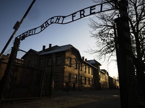 The sun lights the buildings behind the entrance of the former Nazi death camp of Auschwitz-Birkenau in Oswiecim, Germany, Friday, Dec. 6, 2019.A new poll suggests there are some in this country who believe Canada shouldn't intervene militarily if there was a genocide taking place somewhere in the world.