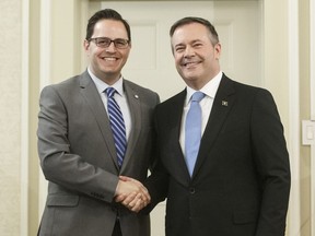 Alberta Premier Jason Kenney shakes hands with Demetrios Nicolaides, Minister of Advanced Education after being sworn into office, in Edmonton on Tuesday April 30, 2019. Alberta is launching a new funding model for post-secondary institutions, tying some of the public money to performance measures.