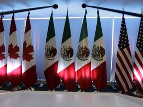 National flags representing Canada, Mexico, and the U.S. are lit by stage lights at the North American Free Trade Agreement, NAFTA, renegotiations, in Mexico City, Tuesday, Sept. 5, 2017. Senators on Capitol Hill have finally approved the latest version of North America's free trade pact.