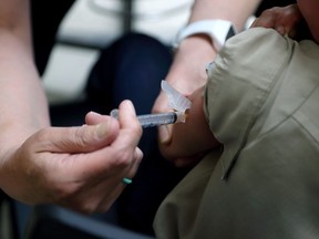 A registered nurse administers a vaccination to a young boy in Mount Vernon, Ohio on May 17, 2019.