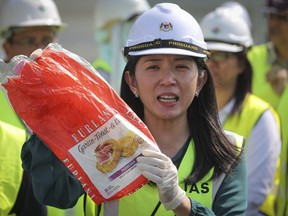 Malaysia's Minister of Energy, Science, Technology, Environment and Climate Change Yeo Bee Yin shows a sample of a plastic waste shipment in Port Klang, Malaysia, Tuesday, May 28, 2019. Malaysia's environment minister says 11 shipping containers of plastic garbage have been returned to Canada after they arrived illegally on Malaysian shores last year.