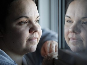 Jessica Reid poses in her Winnipeg apartment Friday, December 20, 2012. Charges have been stayed for a woman who testified that she was tortured, beat and burned in the months leading up to another woman's body being found in a barrel.