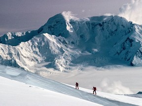 Lisel Currie and Carl Nagy ski roped together on King Trench route of Mt Logan, Mt St Elias in background, Kluane National Park, Yukon in this handout image provided by Pat Morrow. Parks Canada has implemented new rules for climbers on the country's highest peak after having to rescue eight people in seven years.