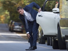 Conservative leader Andrew Scheer stops to fix his pant leg as he gets out of his car prior to making a morning announcement during a campaign stop in Lacolle, Que. Wednesday, October 9, 2019. Outgoing Conservative Leader Scheer's past became a problem during the 2019 federal election, and those vying to replace him will be grilled about theirs.