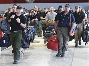 A contingent of 39 firefighters from the United States and Canada arrive at Melbourne Airport in Melbourne, Thursday, January 2, 2020. Another 69 Canadians are heading to Australia this week to help fight the country's worst bushfires in recent memory. Foreign Affairs Minister Francois-Philippe Champagne says on Twitter the deployment comes after Australia requested more help.