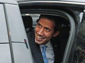 The leader of Venezuela's political opposition Juan Guaido smiles from a car during a visit to Madrid, Spain, Saturday, Jan. 25, 2020.