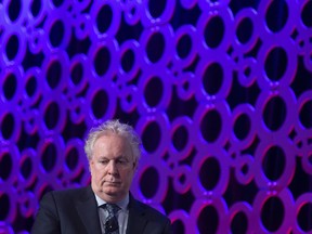 Jean Charest is seen during a panel discussion at the Canadian Aerospace Summit in Ottawa on November 13, 2019. While former Quebec premier Jean Charest mulls a leadership bid for the Conservative Party of Canada, recently unsealed police warrants have given his political opponents plenty of ammunition.