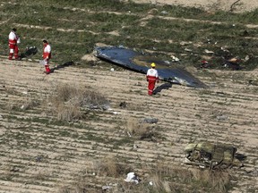 In this Wednesday, Jan. 8, 2020 photo, rescue workers search the scene where a Ukrainian plane crashed in Shahedshahr, southwest of the capital Tehran, Iran.