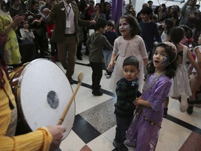In this Saturday, March 9, 2019, Iranian-Canadian children dance with the traditional sound of Saz o Dohol, during the Tirgan Nowruz Festival in Toronto. If there's a sign of how Canada's Iranian diaspora has grown just over the last decade in Canada, consider the story of a festival held in Toronto to mark the Persian New Year, known as Nowruz.