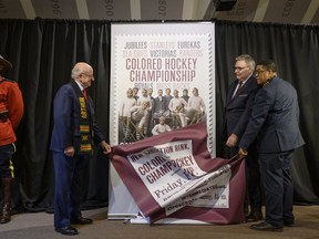From left to right, Arthur J. LeBlanc, Lieutenant Governor of Nova Scotia, Doug Ettinger, President and CEO of Canada Post, and Craig Smith, President of The Black Cultural Society, unveil Canada Post's stamp honouring the Colored Hockey Championship and the all-Black hockey teams in the Maritimes between 1895 and the early 1930s during an event at the Black Cultural Centre for Nova Scotia in Halifax on Thursday, January 23, 2020.