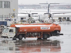 A Swissport refuelling truck is shown at Pierre Elliott Trudeau Airport in Montreal on December 31, 2019. Swissport Canada and the union representing employees who refuel the planes at two Montreal airports will return to the negotiating table tomorrow morning, with workers set to spend a second straight day on the picket lines.