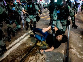 Police detain a man after a pro-democracy march in Hong Kong on Jan. 1, 2020.