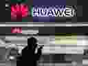 A pedestrian walks past a Huawei store in Beijing, China.