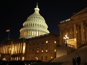 A reporter and camera operator work on the Senate steps during the first evening of President Donald Trump's impeachment trial Jan. 21, 2020 in Washington, DC.