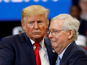 Senator Mitch McConnell hugs U.S. President Donald Trump at a Keep America Great Rally in November 2019.