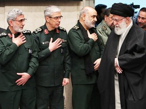 Iran’s Supreme Leader Ayatollah Ali Khamenei greets, from left, newly appointed commander of the Quds Force of the Islamic Revolutionary Guard Corps Esmail Qaani, Iranian Armed Forces Chief of Staff Major General Mohammad Bagheri and Iranian Islamic Revolutionary Guard Corps (IRGC) Chief Commander Hossein Salami at a mourning ceremony in Tehran for slain top general Qassem Soleimani on Jan. 9.