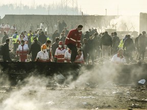 Rescue workers search the wreckage of a Boeing Co. 737-800 aircraft, operated by Ukraine International Airlines, which crashed shortly after takeoff near Shahedshahr, Iran, on Wednesday, Jan. 8, 2020. The passenger jet, Flight 752, bound for Ukraine crashed shortly after takeoff in Iran, killing everyone on board.