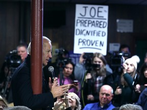 Democratic presidential candidate, former vice-president Joe Biden talks to campaign volunteers during a stop in Davenport, Iowa, on Jan. 28, 2020.