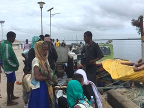 Travellers gather, stranded at the Lamu jetty, following an attack by Somalia's Islamist group al Shabaab on a military base in Manda, Lamu, Kenya January 5, 2020.