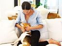 Meghan Markle cuddles her dog, Guy, on the couch. 